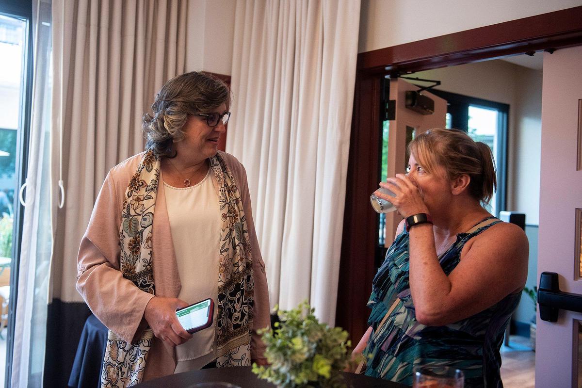 Merced County District Attorney Kimberly Helms Lewis, left, speaks with guests during a campaign party at the El Capitan Hotel in Merced, Calif., on Tuesday, June 7, 2022.