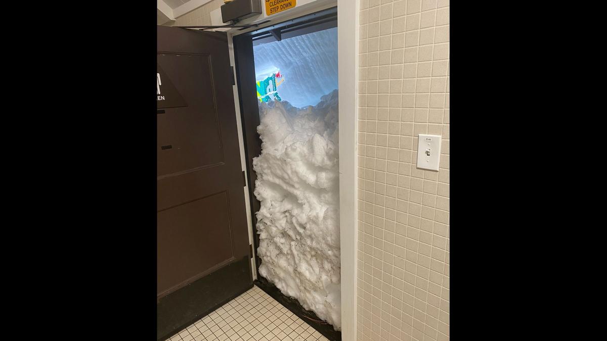 Snow blocks a restroom door in Curry Village at Yosemite National Park. Yosemite is closed to visitors after the park experienced significant snowfall with some areas recording up to 15 feet of snow, according to the National Park Service Facebook post on Tuesday, Feb. 28, 2023. Image courtesy of Yosemite National Park.