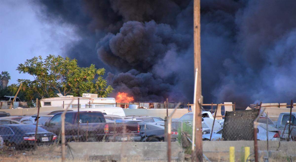 Firefighters battled a fire that damaged an estimated 100 vehicles in two Merced auto yards on Friday, July 9, 2021.