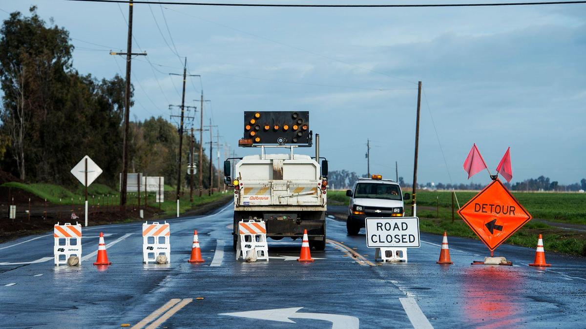 The California Department of Transportation closes a section of Highway 59 at the intersection of Sandy Mush Road in rural Merced County, Calif., on Thursday, Jan. 19, 2017.