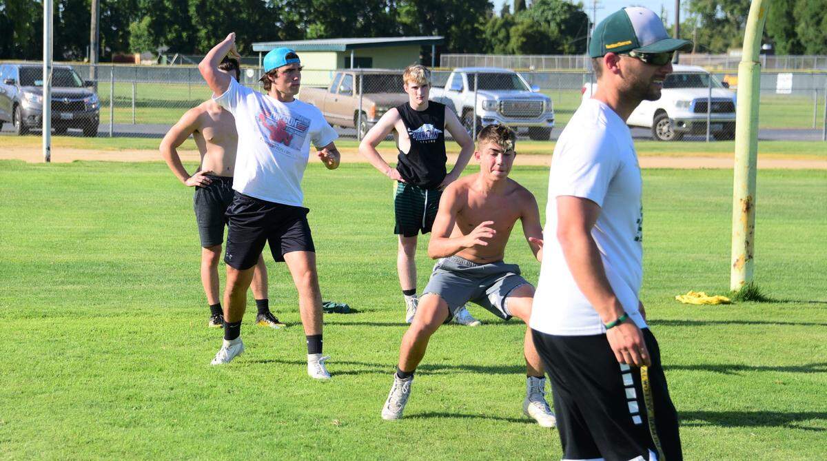 Hilmar High quarterback Seth Miguel mimicks throwing a pass during a workout on Wednesday, June 10, 2020 at McSweeney Field at Hilmar High School.