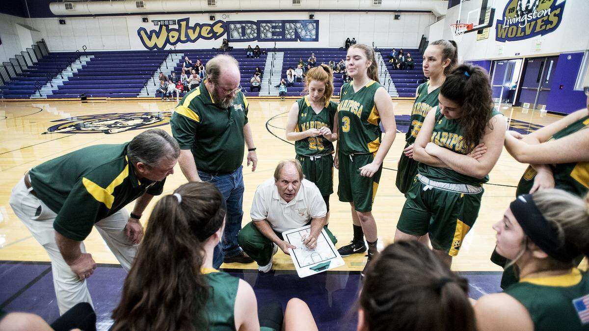 Mariposa coach Trace DeSandres goes over a play with the Grizzlies girls basketball team during a game at Livingston High in 2018. DeSandres, who is in his final year as a head coach after 23 years, will coach in his first section final on Saturday at the Golden One Center in Sacramento.