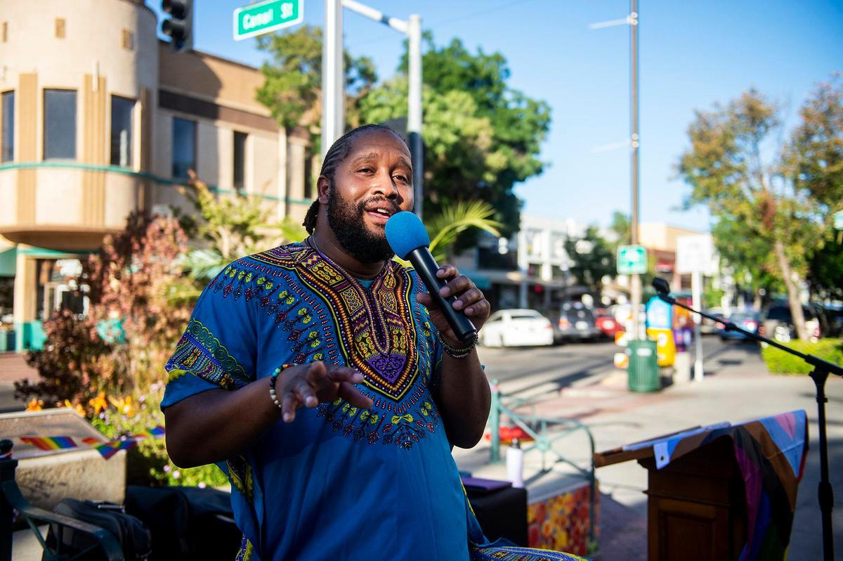 Jared Jarvis, 39, sings prior to the Pride Progress flag raising ceremony at Bob Hart Square in Merced, Calif., on Wednesday, June 1, 2022. The Merced City Council approved the addition of the pride flag to the regular flag calendar, meaning the flag will fly over Bob Hart Square annually during the month of June.