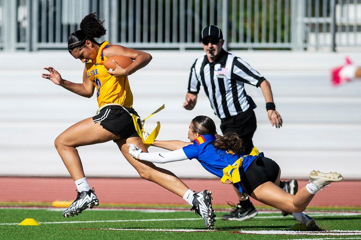 Gold All-Star Averie Steverson (10) representing Merced, attempts to evade a defender during the Merced County All-Star Girls Flag Football Game at Golden Valley High School in Merced, Calif., on Saturday, June 15, 2024. The Blue All-Stars beat the Gold All-Stars 20-12.