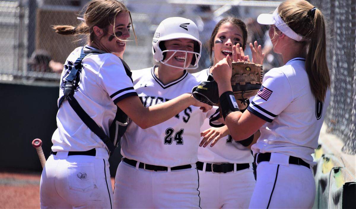 Stone Ridge Christian junior Alyssa Villa (24) is greeted by teammates after scoring a run during the Sac-Joaquin Section Division VII championship game against Big Valley Christian on Saturday, May 21, 2022 at the San Joaquin Delta Softball Complex in Stockton, Calif.