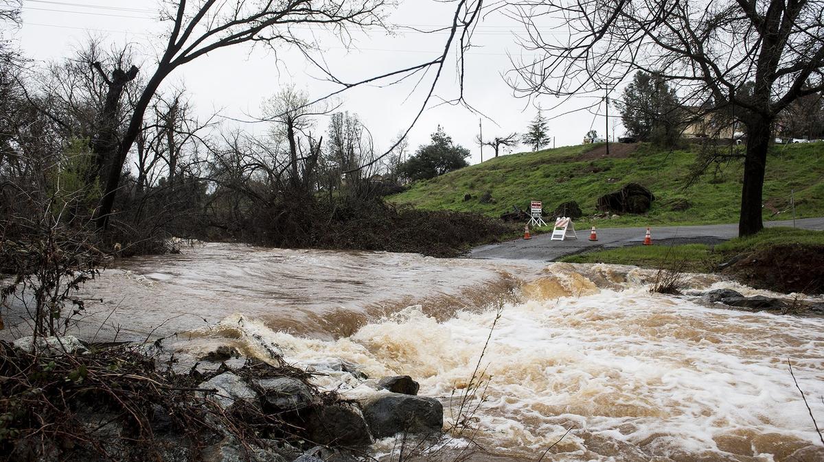 Water floods a section of Stroming Road in Mariposa, Calif., on Thursday, March 22, 2018.