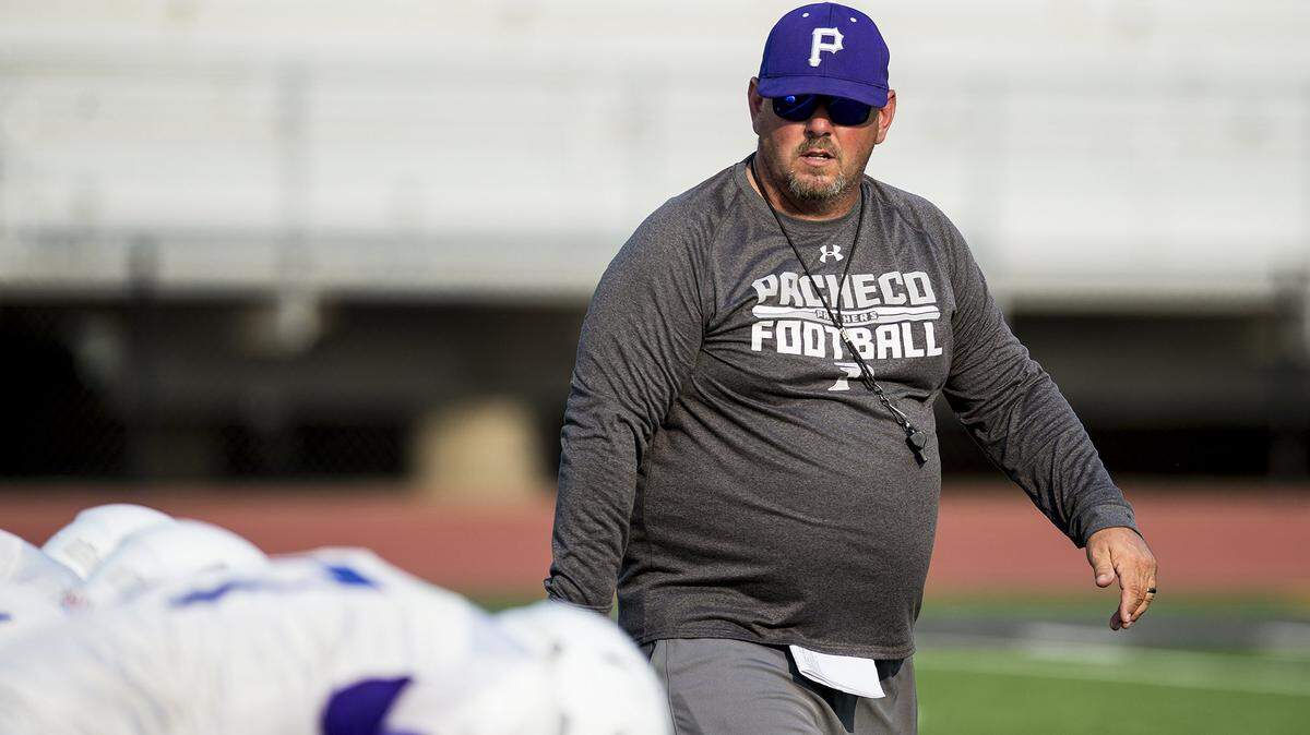 Pacheco head coach David Snapp walks across the field during football practice at Pacheco High School in Los Banos earlier this season. Snapp announced he has resigned as the Panthers head coach.
