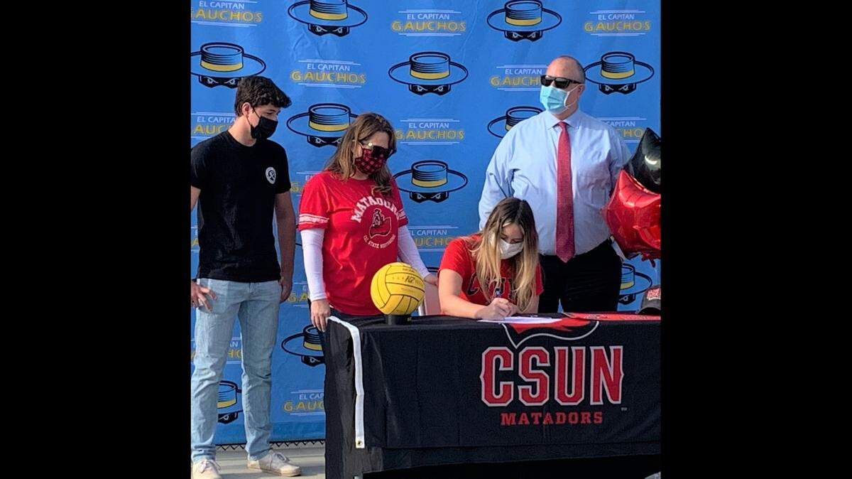 El Capitan High senior Alexis Smith signs her national letter of intent to accept an athletic scholarship to play water polo at Cal State Northridge as her brother Ryan, mother Dara and father Kevin look on at El Capitan High School on Thursday, Nov. 12, 2020 in Merced, Calif.