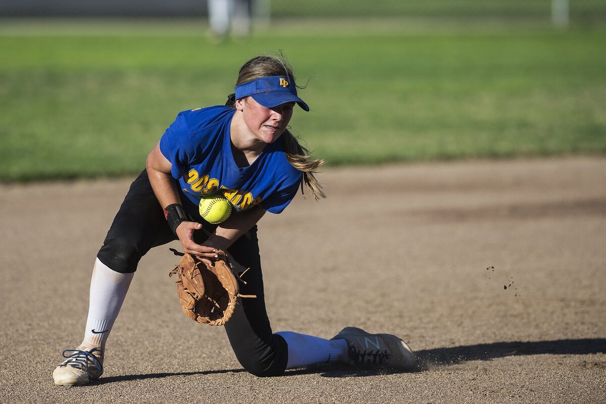 Dos Palos senior Teya Vincent knocks down a ground ball to shortstop during the annual Paul Leonardo Memorial All-Star Game at Livingston High School in Livingston, Calif., on Tuesday, June 12, 2018.