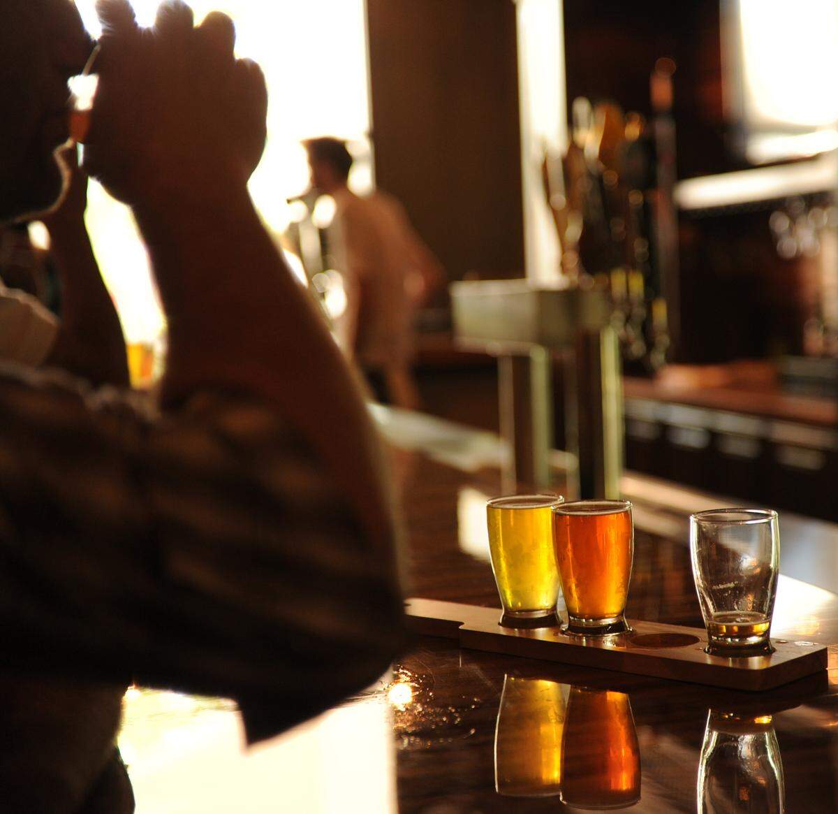 A customer enjoys a sample tasting during opening day at the 17th Street Public House bar in downtown Merced Thursday. (7-11-13)