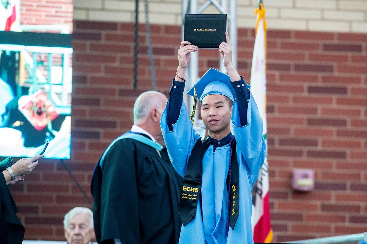 A graduate celebrates after walking on stage to receive a diploma during a commencement ceremony for the El Capitan High School class of 2022 on the El Capitan High School campus in Merced, Calif., on Thursday, June 2, 2022.