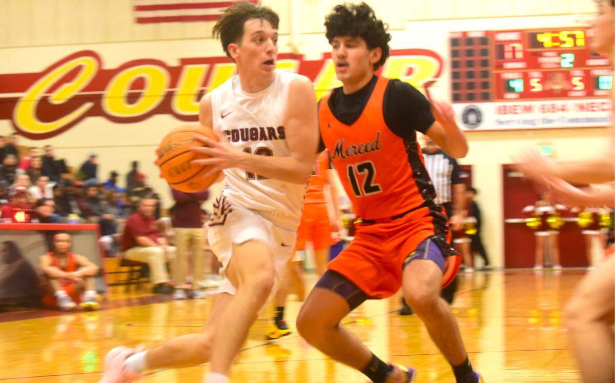 Golden Valley High School senior Braden Castleton (12) drives to the basket as Merced’s Aiden Matsuo (12) defends during a basketball game on Wednesday, Jan. 3, 2023 at Cougar Arena.