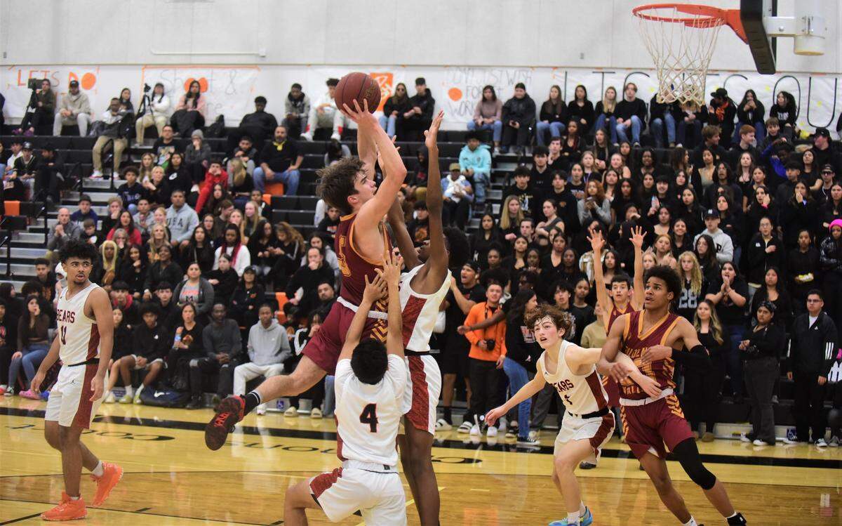 Golden Valley High junior Joseph Spielman (5) attempts to go up for a shot over two Merced defenders during a game on Vince Clemons Court at Merced High School on Friday, Jan. 20, 2023.