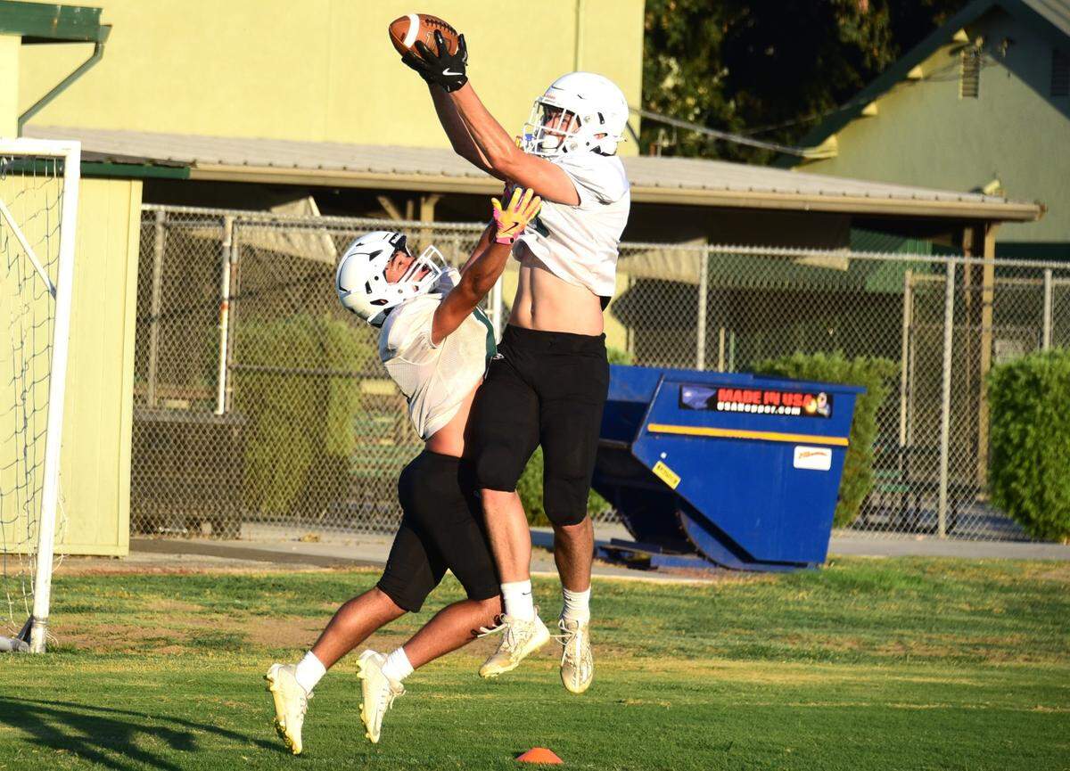 Hilmar High senior receiver John Labno (13) hauls in a touchdown catch during practice on Tuesday, Aug. 6, 2024.