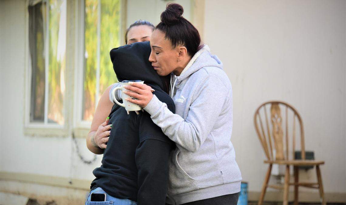 Victoria Lopez hugs daughter Yesenia Jaurigue during a remembrance on the one-year anniversary of the fatal shooting of 19-year Tatyanna Lopez in Merced on April 18, 2022.