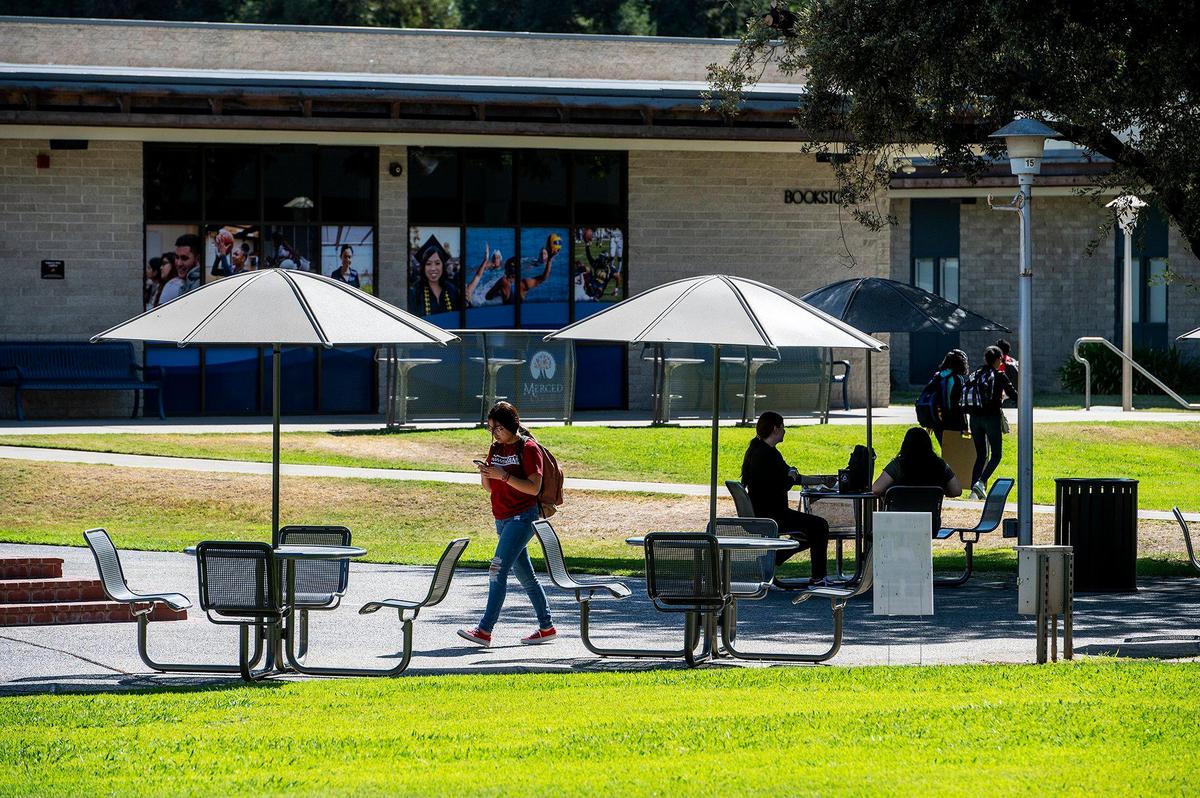People walk across the campus of Merced College in Merced, Calif., on Thursday, Aug. 25, 2022.