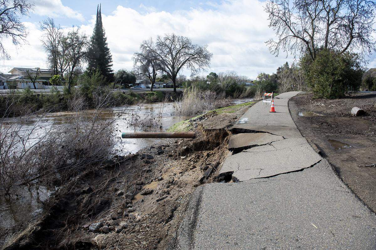A damaged section of pathway along East North Bear Creek Drive between Montana Avenue and Forist Lane in Merced, Calif., on Monday, Jan. 16, 2023.