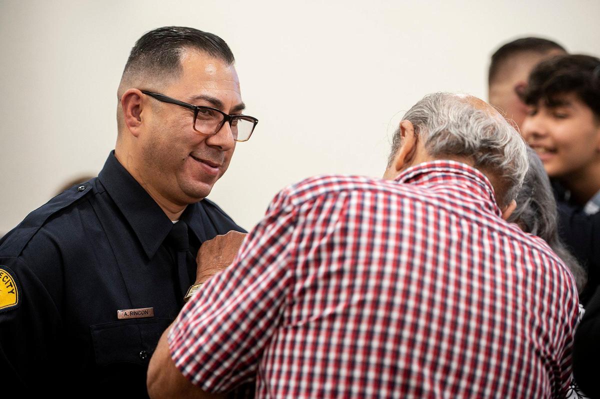 Gustine Police Department Reserve Officer Arthur Rincon has his badge pinned on by his father Albert, during a swearing in ceremony for four new Gustine Police Department Reserve Officers in Gustine, Calif., on Tuesday, June 20, 2023.
