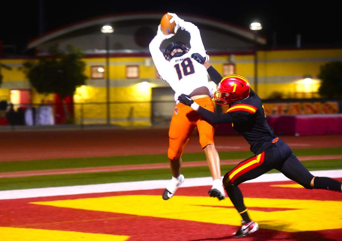 Merced High School receiver Jeremy Garcia (18) hauls in a 38-yard touchdown pass during a playoff game against Oakdale on Friday, Nov. 11, 2023 at the Corral in Oakdale, Calif.
