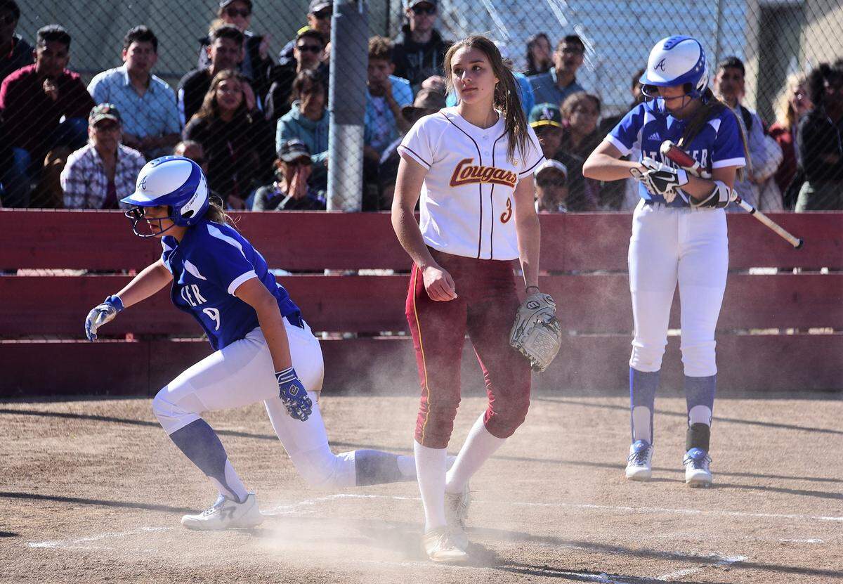 Golden Valley pitcher Marissa Bertuccio covers home as Atwater’s Alexa Ortiz (9) slides across the plate after a passed ball during the Falcons 6-1 win over the Cougars on Wednesday, April 10, 2019 at Golden Valley High in Merced, Calif.