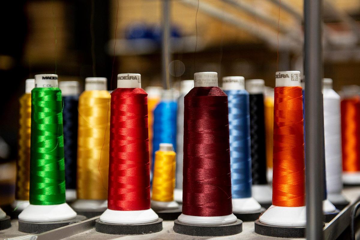 Spools of thread on top embroidery machine at McNamara Sports, located at 437 W. 18th Street in Merced, Calif., on Monday, May 8, 2023. The family owned store which sells athletic equipment, team uniforms, business apparel and offers screen printing and embroidery services, is celebrating 100 years in business