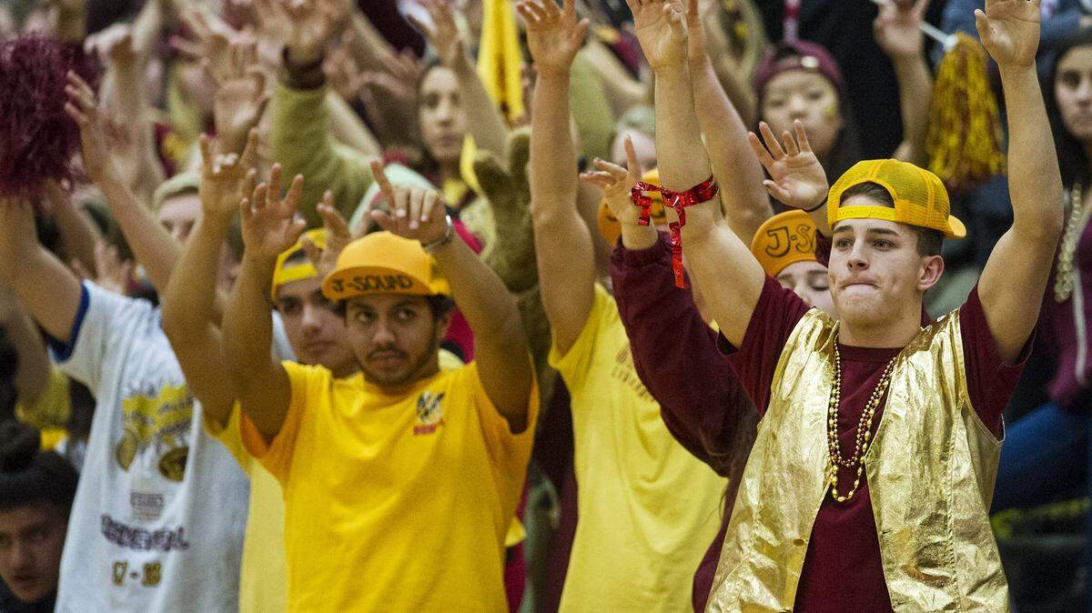 The Golden Valley student section raises their hands during a Cougars free-throw during a game against Merced at Golden Valley High School in Merced, Calif., on Friday, Jan. 19, 2018. The Cougars beat the Bears 57-56.