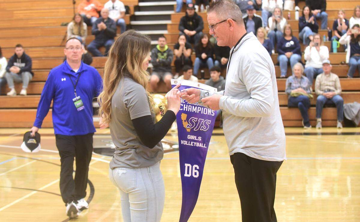 Stone Ridge Christian High School first-year girls volleyball coach Jessica Pinasco-Radomskiy receives the blue section championship banner from Sac-Joaquin Section commissioner Mike Garrison on Saturday, Nov. 4, 2023 at Modesto Junior College.