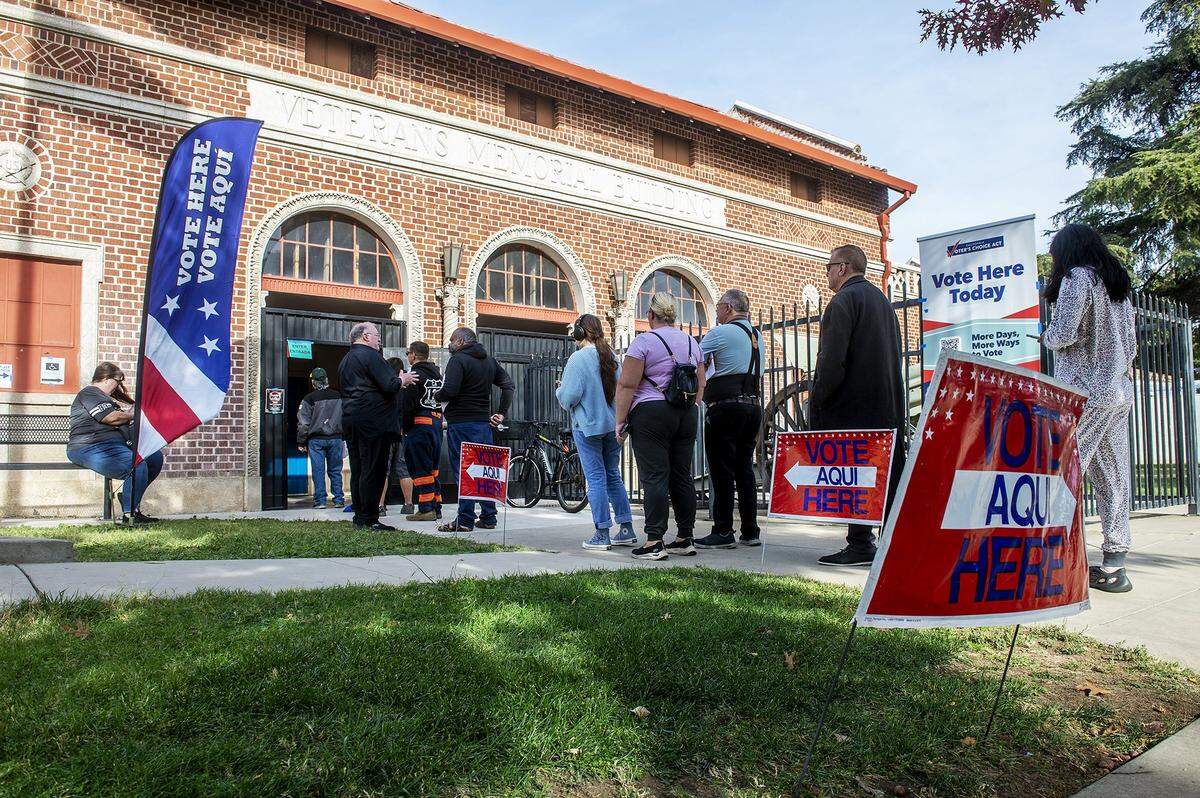 People wait in line to cast their vote at the Veteran Memorial Building in Merced, Calif., on Tuesday, Nov. 5, 2024. 