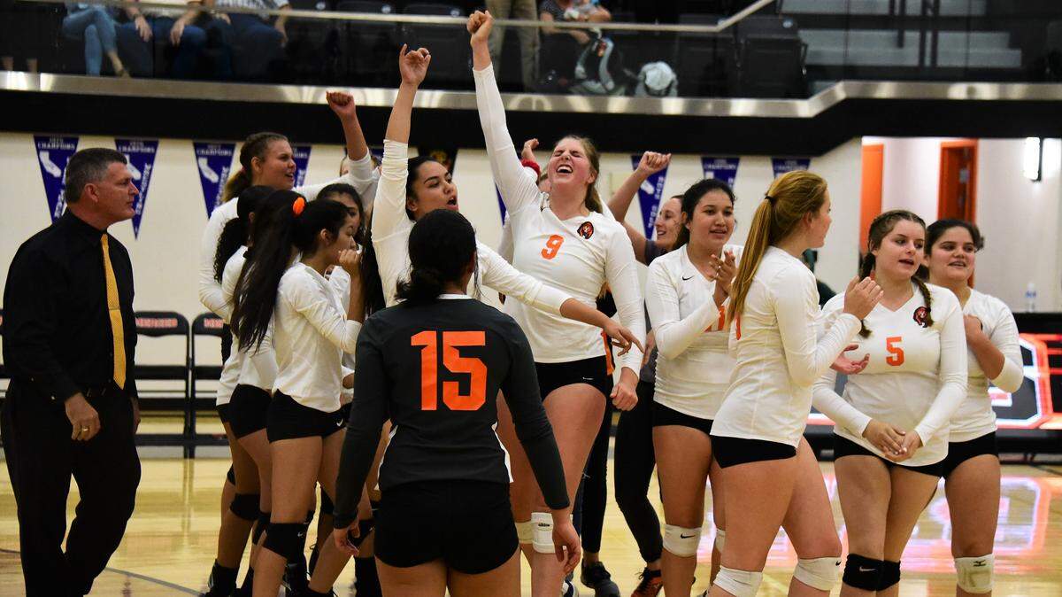 The Merced High girls volleyball team celebrates their 3-0 win over Golden Valley on Wednesday, Oct. 23, 2019. The Bears clinched a playoff spot with the sweep over the Cougars.