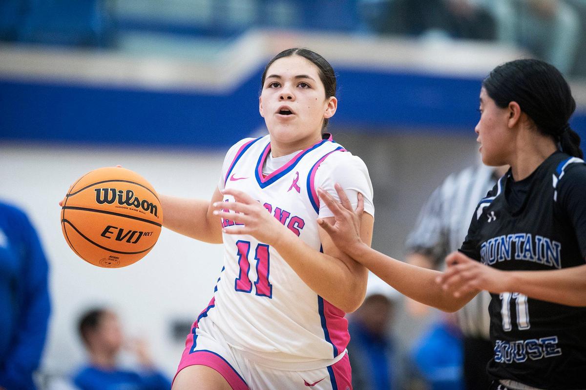 Atwater sophomore Natalia Melgoza (11), left, attempts to dribble past Mountain House freshman Surianti Bakri (11), right, during a CIF Sac-Joaquin Section Division 2 playoff game at Atwater High School in Atwater, Calif., on Wednesday, Feb. 14, 2024. The Falcons beat the Mustangs 95-59.