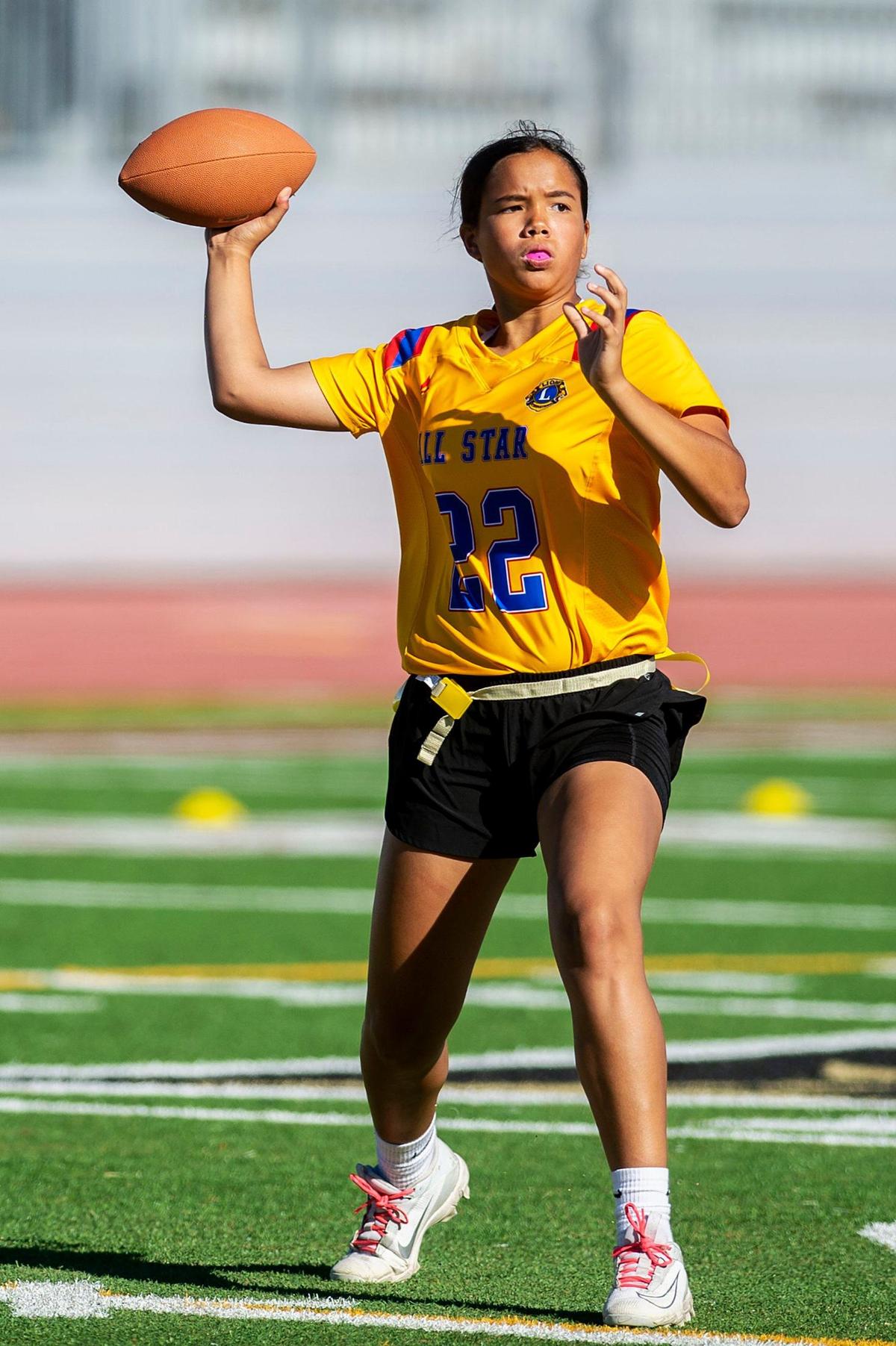 Gold All-Star quarterback Antonia Lejarde (22) representing Merced, drops back to throw a pass during the Merced County All-Star Girls Flag Football Game at Golden Valley High School in Merced, Calif., on Saturday, June 15, 2024. The Blue All-Stars beat the Gold All-Stars 20-12.