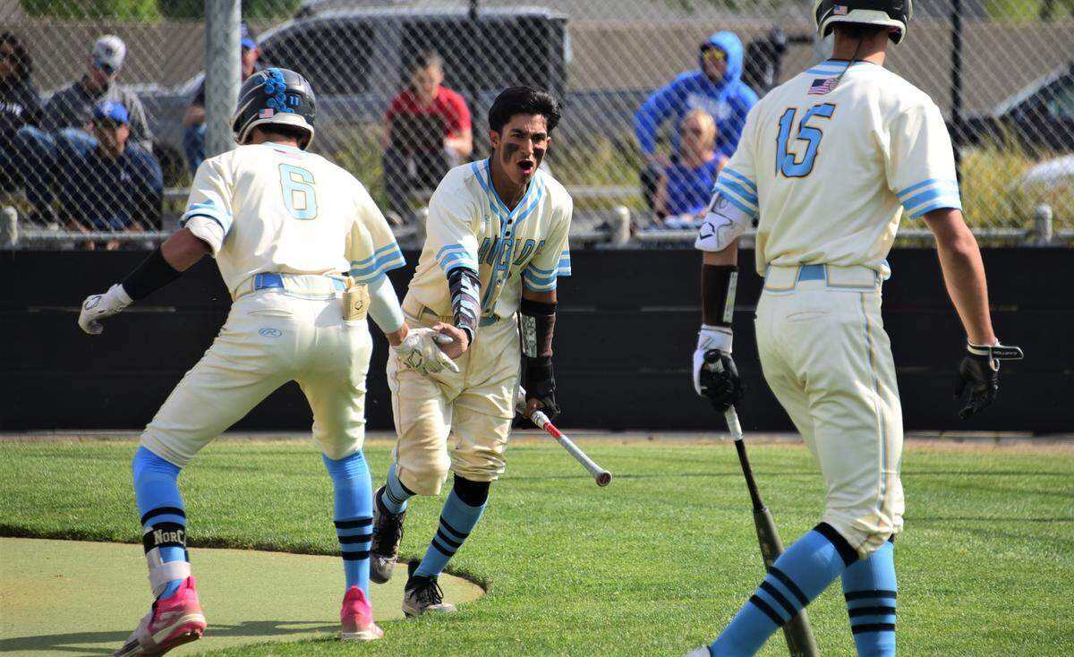 El Capitan High School sophomore Braylen Centeno (9) celebrates with teammates after scoring a first-inning run during a playoff game against Bear Creek on Tuesday, May 9, 2023 at El Capitan High School.