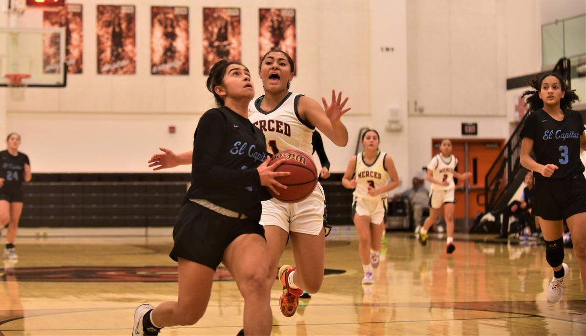 El Capitan High School sophomore Shantelle Magana (13) goes up for a shot as Merced High senior Mylah Steverson tries to distract her during a game on Tuesday, Jan. 3, 2022 at Merced High School.