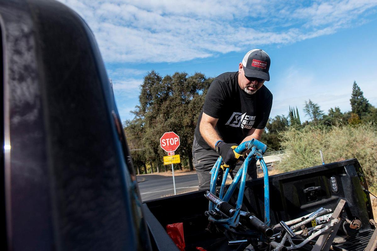 Volunteer Justin Hicks, 43, of Merced, places bicycle parts and other metal scrap collected from along the banks of Bear Creek into the bed of a truck during a cleanup event presented by the Merced non-profit Bear Creek Yacht Club, in Merced, Calif., on Saturday, Oct. 14, 2023.