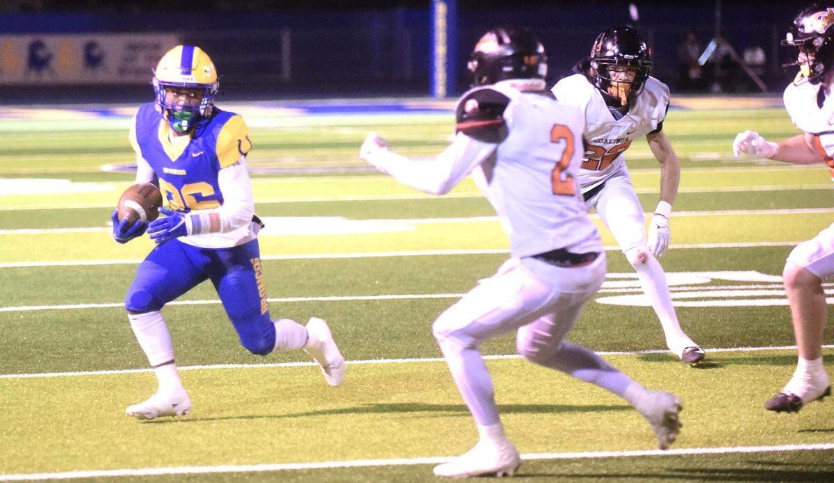 Dos Palos High School sophomore running back Andre Flores (26) runs the ball up field after hauling in a reception during a game against Coalinga on Friday, Oct. 28, 2023.