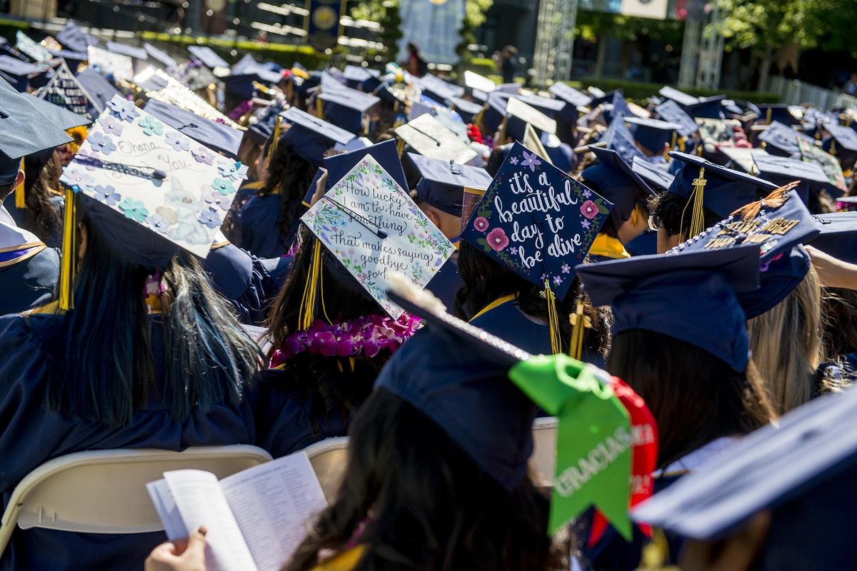 Caps containing decorations and messages are worn by graduates during the University of California, Merced School of Social Sciences, Humanities and Arts spring commencement in the Carol Tomlinson-Keasey Quad on the UC Merced campus in Merced, Calif., on Saturday, May 12, 2018.