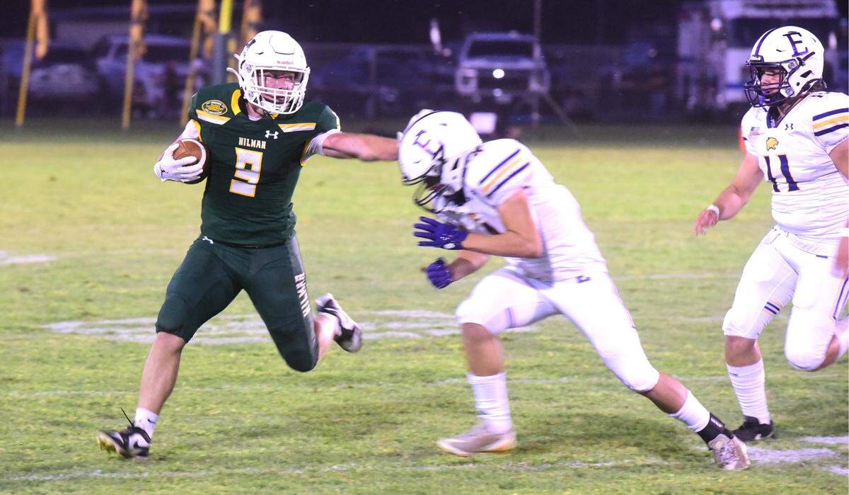 Hilmar High senior Caden Bailey trys to stiff-arm an Escalon defender during a game on Friday, Sept. 27, 2024 at McSweeney Field.