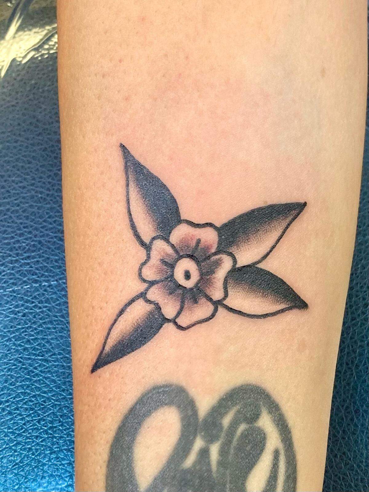 Small tattoo of a flower on local customer by Main Street Tattoo and Body Piercing artist, Lindsey Chastain. On Friday the 13th, tattoo artists offer an array of small, pre-designed options for customers at a reduced price. Courtesy of Lindsey Chastain.
