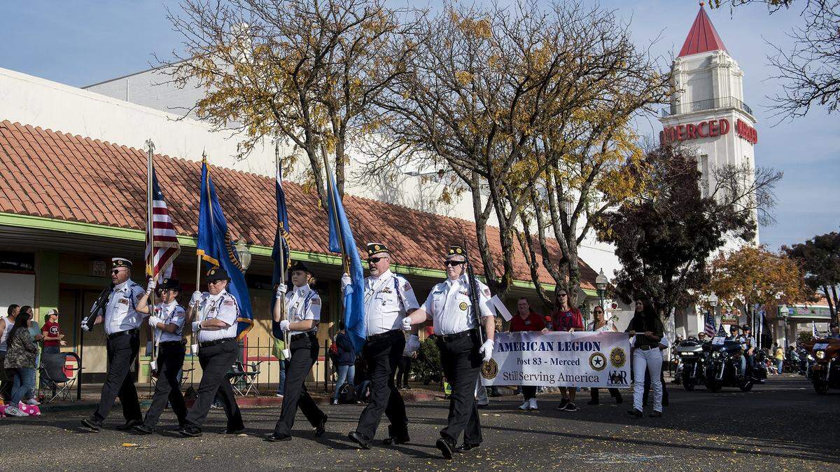 The Merced American Legion Post 83 marches along West Main Street during the Veterans Day parade in Merced, Calif., on Monday, Nov. 11, 2019. A drive-thru parade is scheduled to be held Thursday.