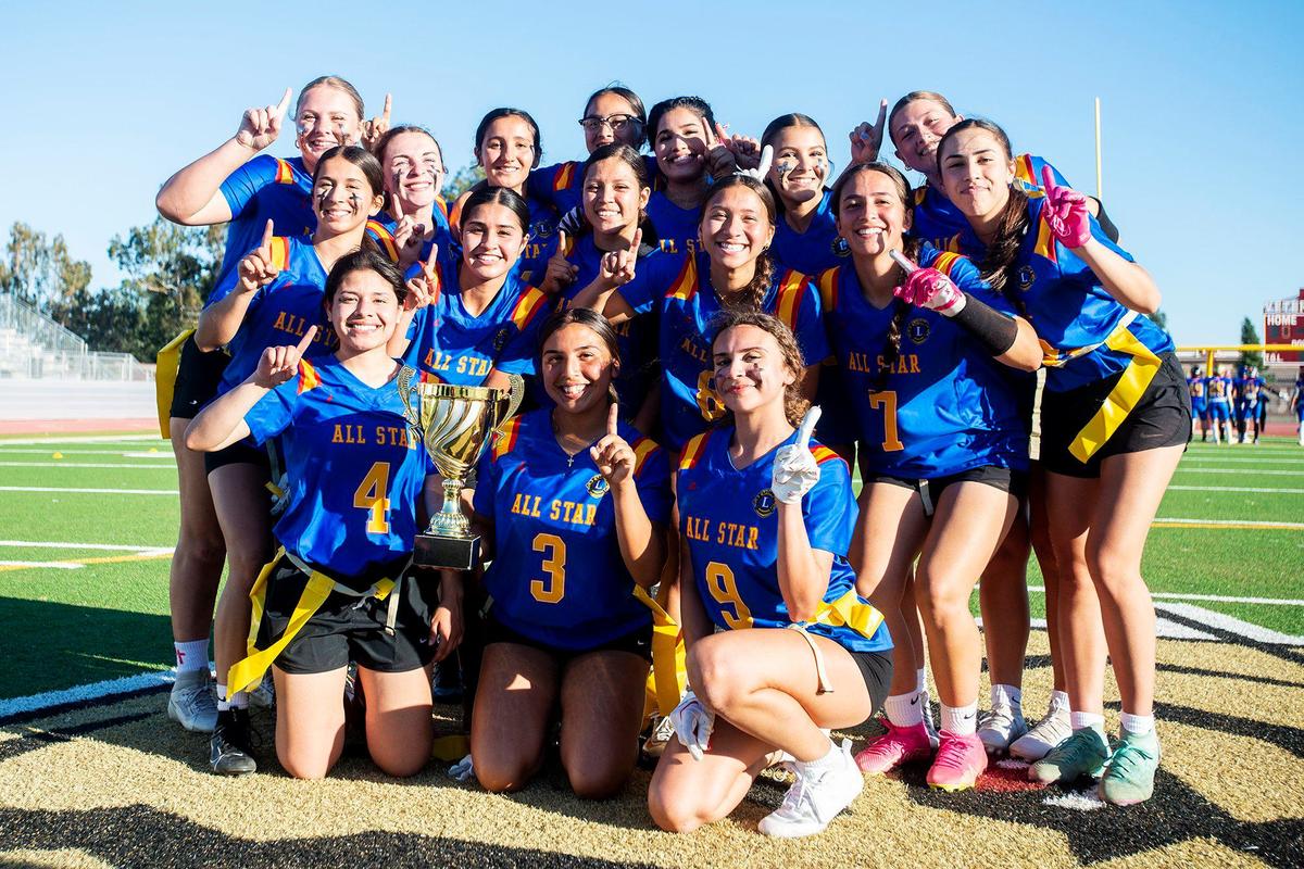 The Blue All-Stars pose for photos as they celebrate a 20-12 victory over the Gold All-Stars in the Merced County All-Star Girls Flag Football Game at Golden Valley High School in Merced, Calif., on Saturday, June 15, 2024.