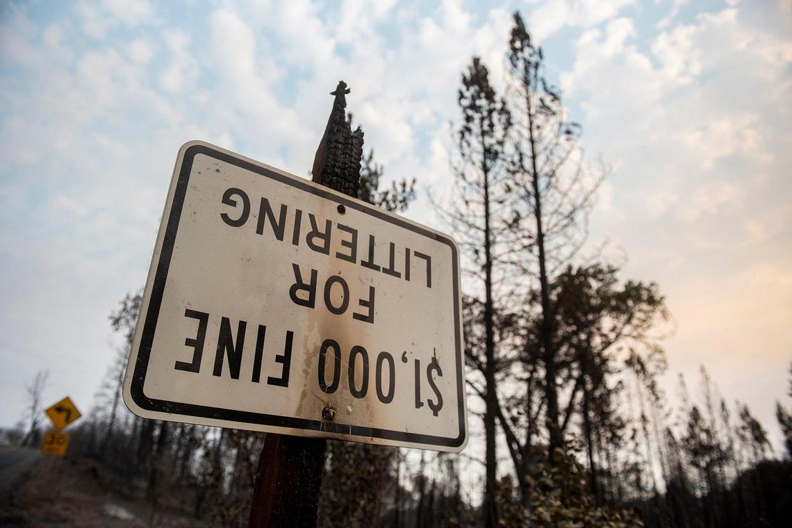 A sign damaged by fire along Triangle Road as firefighters continue to battle the Oak Fire in Mariposa County, Calif., on Tuesday, July 26, 2022.