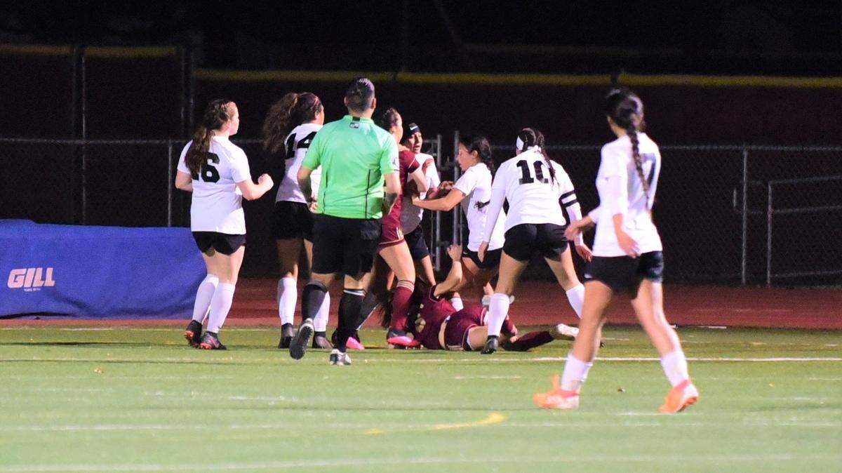 Golden Valley’s Angela Gaeta is pushed to the ground by a Merced’s Evelyn Flores (10) after Gaeta threw a punch at a Merced player during a game on Thursday night at Veterans Stadium. Four players were ejected and the game was stopped with 16 minutes and 30 seconds left in the match.