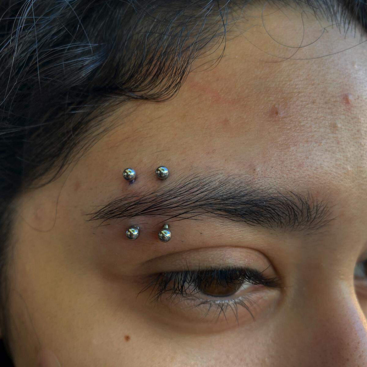 Two vertical eyebrow piercings on customer’s right eyebrow by Main Street Tattoo and Body Piercing artist, Jess Roe. Courtesy of Jess Roe.