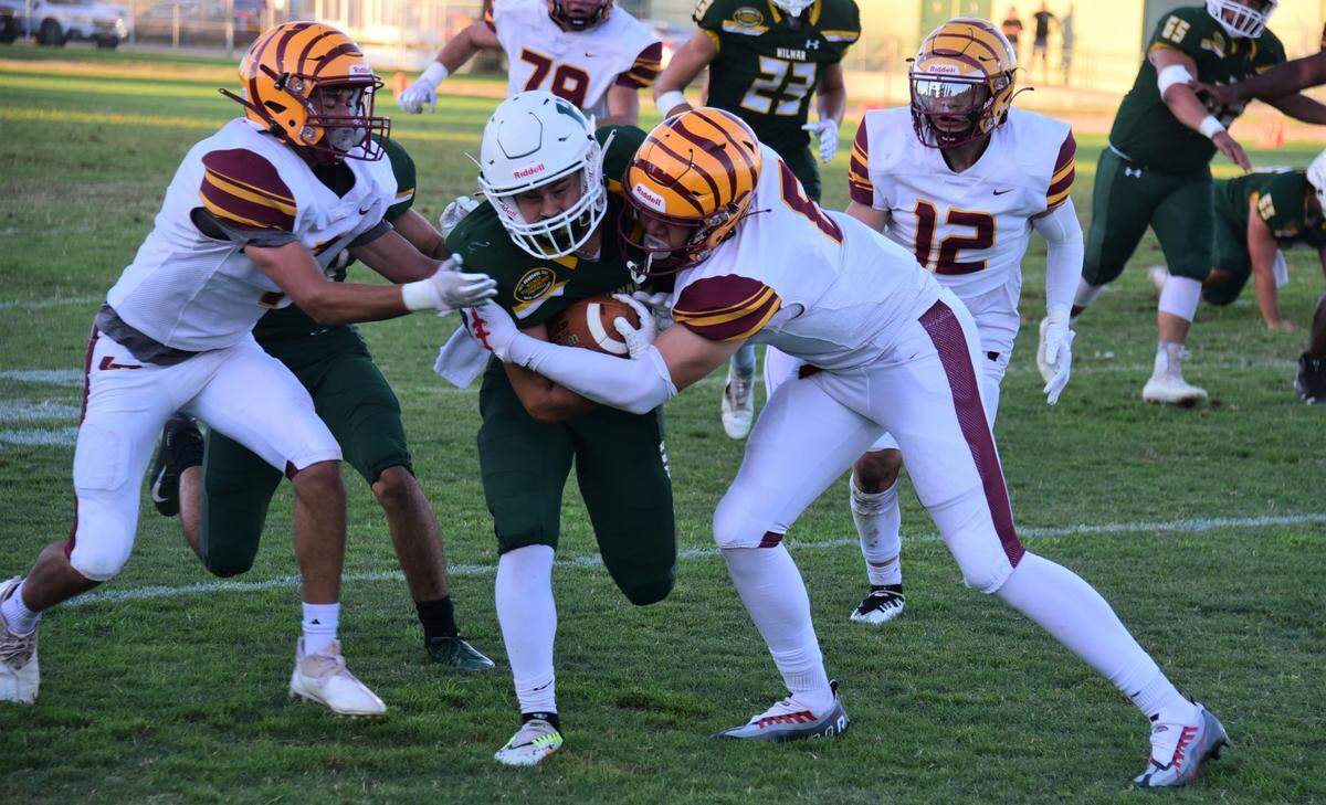 Hilmar High School receiver Jax Branco runs up field befores he’s brought down by Los Banos defenders Kayson Welch (8) and George Garcia (7) on Friday, Aug. 26, 2022.