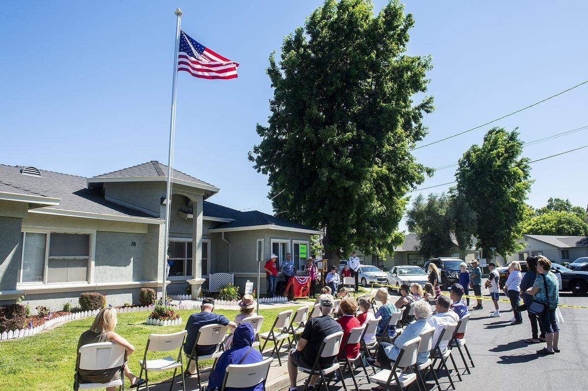 Community members look on during a flag raising ceremony inside the Castlewood community in Atwater, Calif., on Tuesday, June 14, 2022.