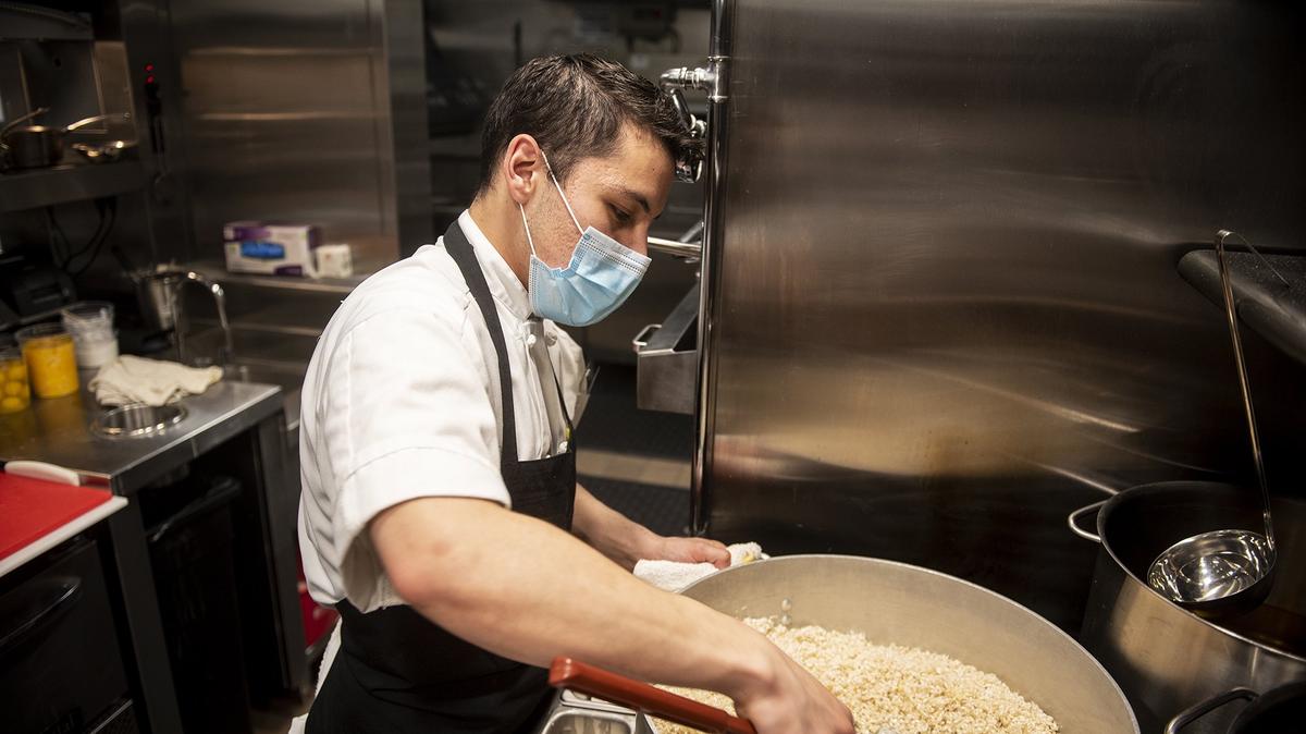 Line cook Daniel Herrera, 27, of Le Grand, cooks rice for a risotto at the Rainbird restaurant inside the El Capitan Hotel located at 609 W. Main Street in Merced, Calif., on Thursday, Feb. 3, 2022.