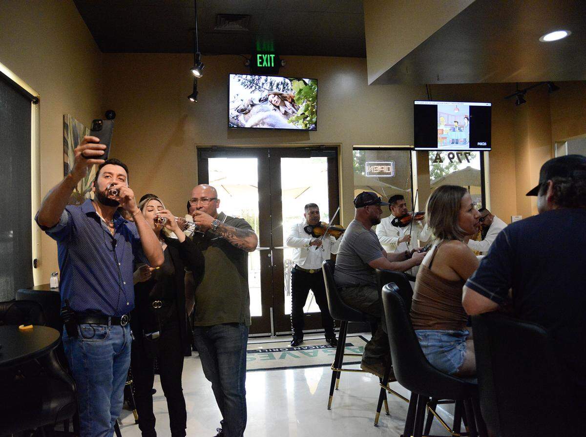 Efraín Lupian (blue shirt), Karina Lupian (black shirt), and Nico Torres (green shirt) on Friday June 12 at Agaves grand opening.