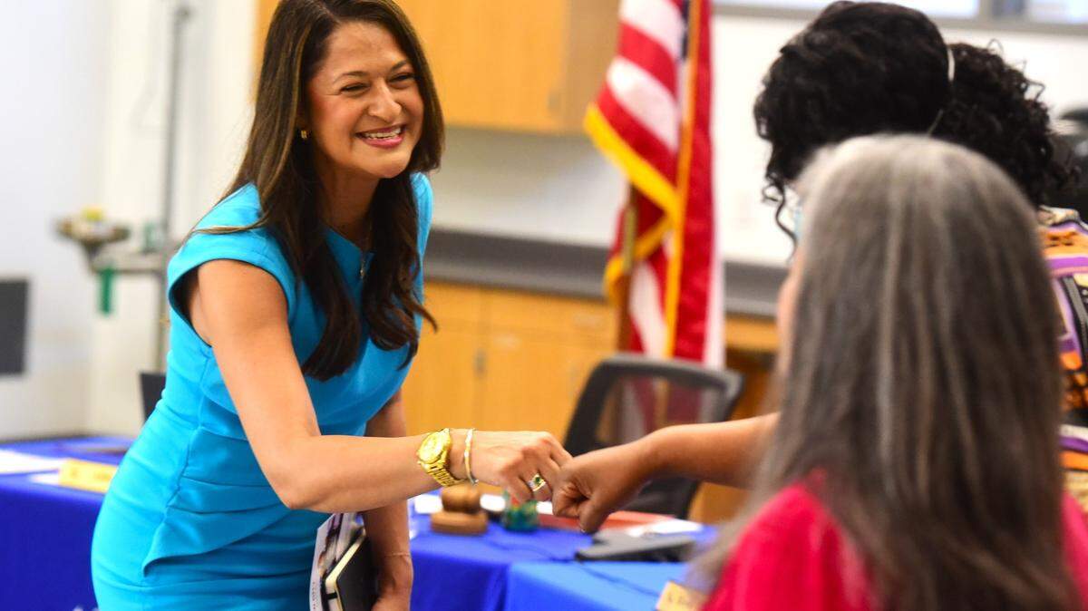 New Merced City School District superintendent Julianna Stocking shakes the hands of MCSD board members. Stocking was appointed as the new superintendent during a school board meeting on Tuesday, June 11, 2024.