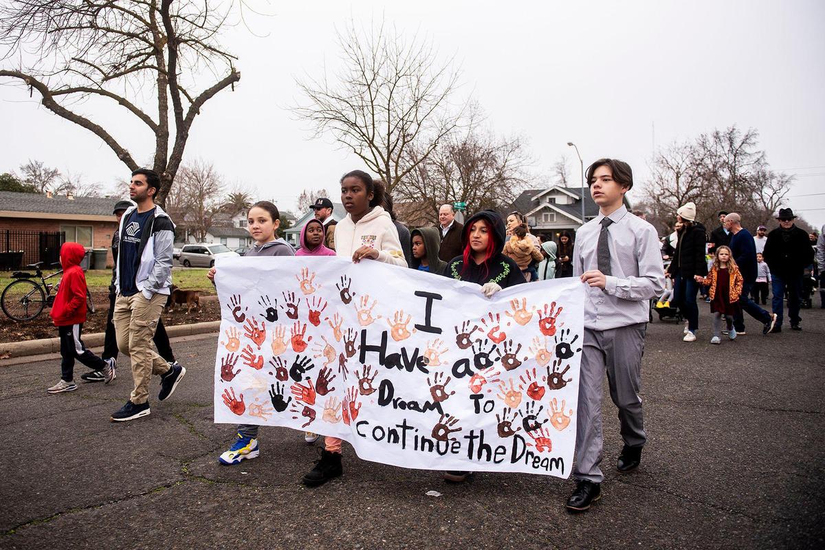 Marchers walk along Martin Luther King Jr. Way during the annual Peace and Unity March to honor the legacy of late civil rights leader Rev. Dr. Martin Luther King Jr. in Merced, Calif., on Monday, Jan 15, 2024.