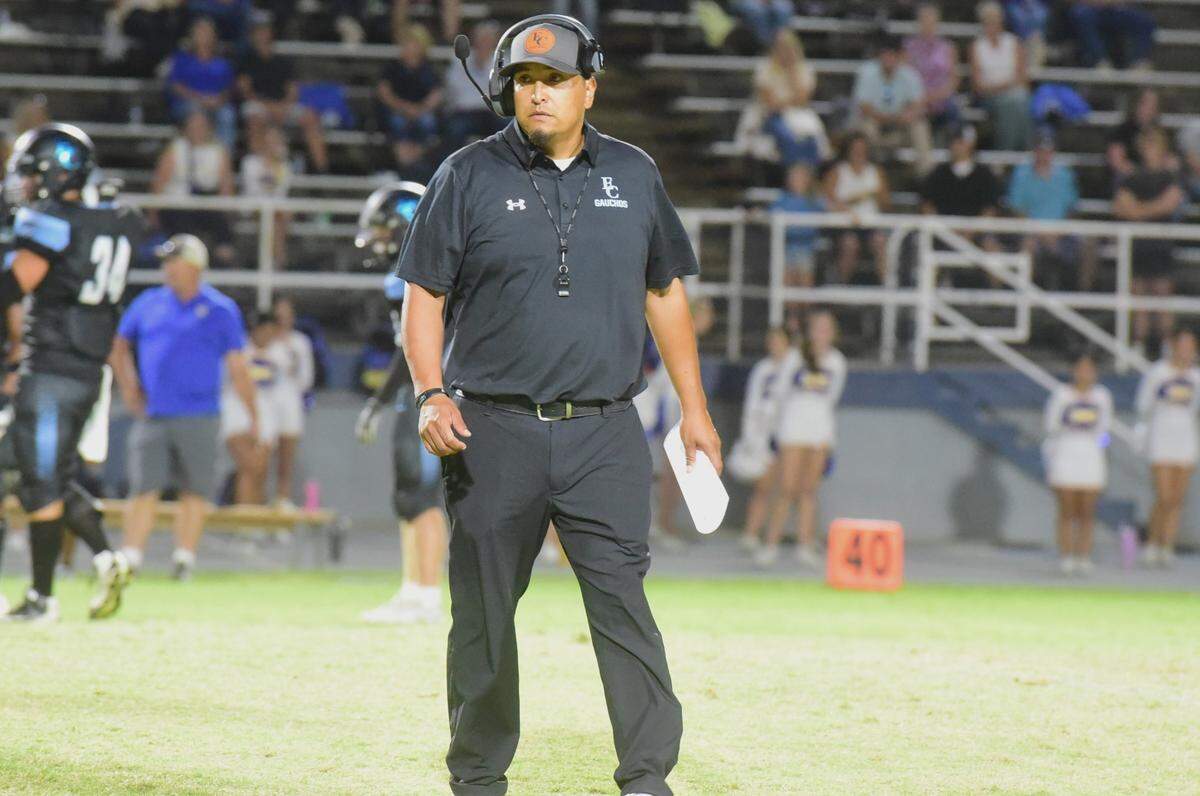 El Capitan High head football coach Xavier Ramirez walks toward the Gauchos’ sideline during a game against Ripon Christian on Friday, Aug. 30, 2024 at Merced College.